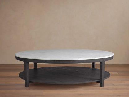Danny Round Coffee Table with a white Carrara marble top and ebony oak base, featuring a two-tier design on a wooden floor background.