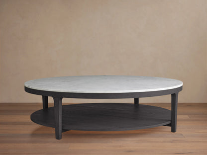 Danny Round Coffee Table with a white Carrara marble top and ebony oak base, featuring a two-tier design on a wooden floor background.