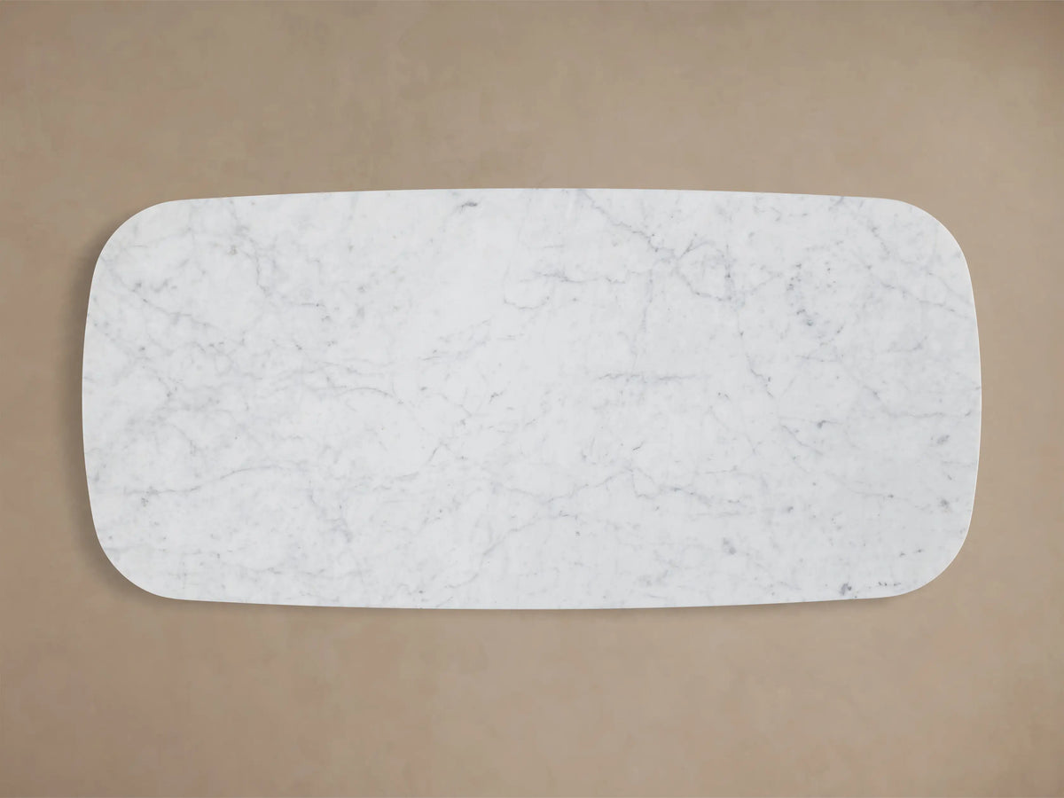 Top-down view of a rectangular white marble slab with rounded corners and intricate grey veining.