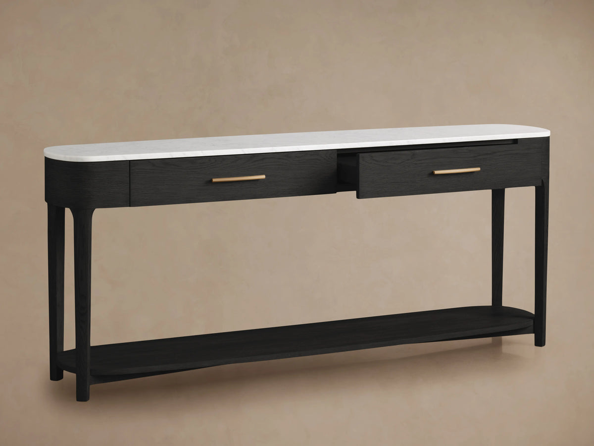 Close-up of Danny Console Table. White Carrara marble top, ebony oak wood drawer with brass pull, partially open.