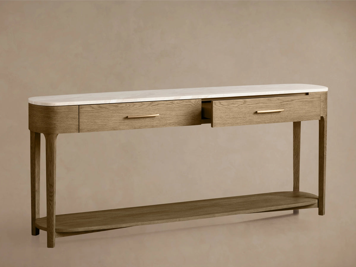 Oak Danny Console Table with white marble top, featuring two drawers with brass pulls. One drawer is slightly open.