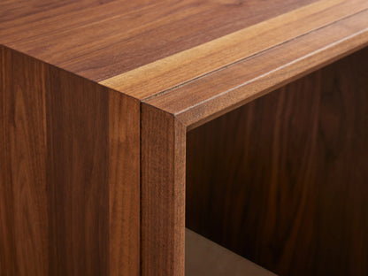 Elien Nesting End Table in natural wood finish, featuring a minimalist cubic design, placed on a wooden floor against a light wall.