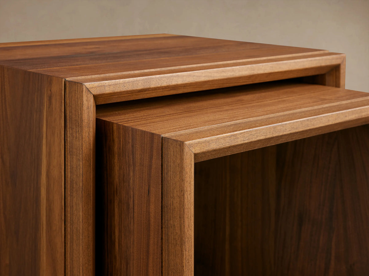 Elien Nesting End Table set, two wooden tables with a sleek design, stacked together on a wooden floor.