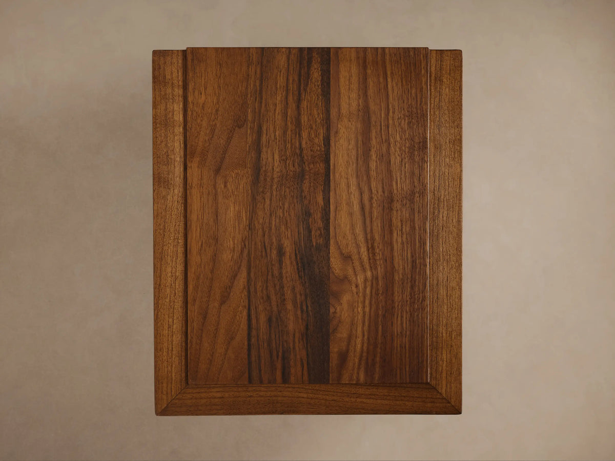 Elien C Table with a polished walnut finish, showing the thick rectangular tabletop and sturdy, minimalist vertical supports.