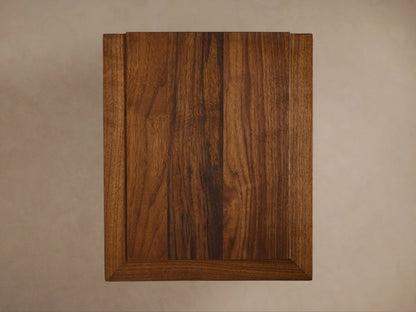 Elien C Table with a polished walnut finish, showing the thick rectangular tabletop and sturdy, minimalist vertical supports.