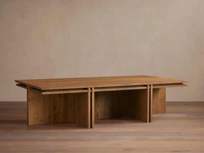 Eaves Coffee Table: Modern rectangular solid oak wood with double-frame design, warm brown finish, on a wood floor.