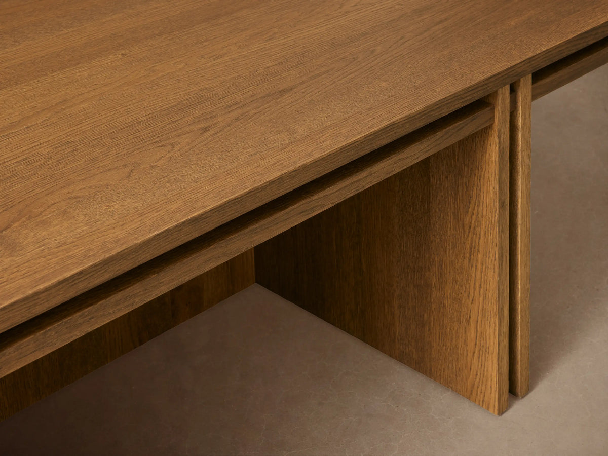 Eaves Coffee Table, rectangular medium brown oak, modern double-frame design with layered top and sturdy vertical panel base on wood floor.