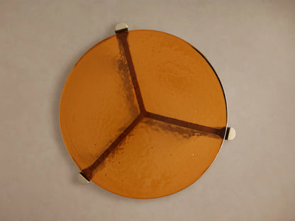 Ezio Martini Table amber glass tabletop viewed from above, showing unique bubble effect and three dark radial lines on its surface.