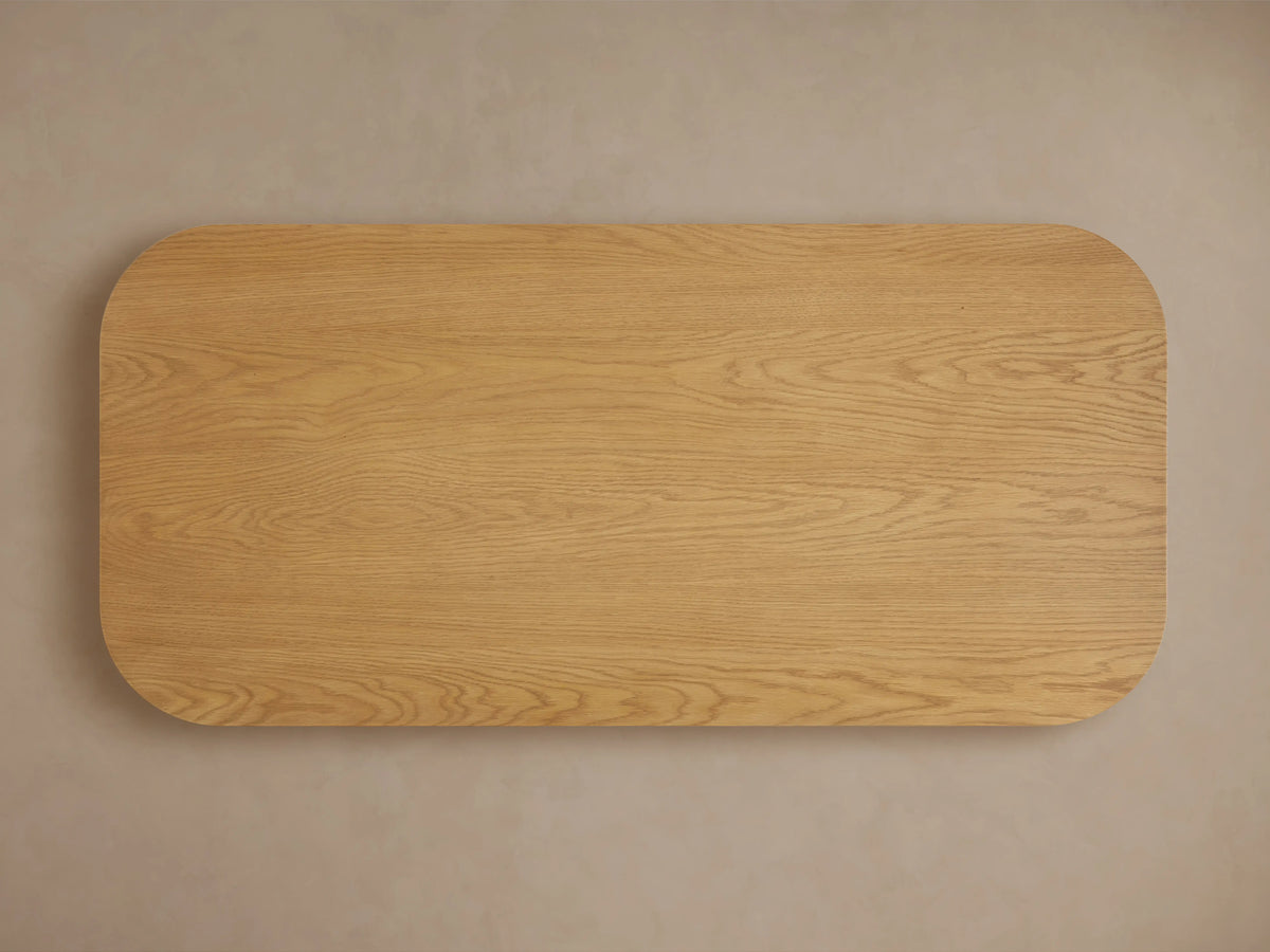 Finnley Wood Coffee Table featuring a honey finish with vertical slats, constructed from white oak with a rounded edge design.