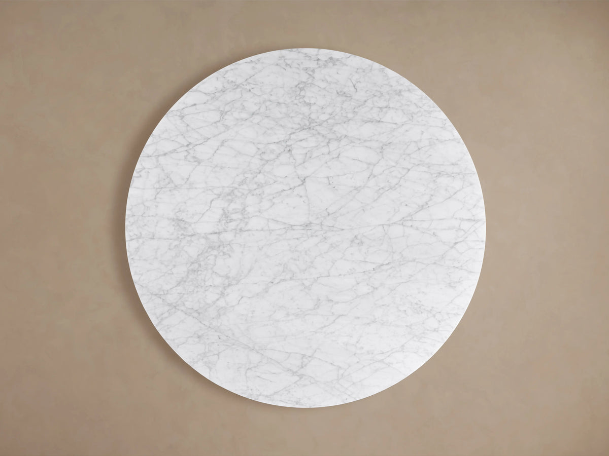 Finnley Round Coffee Table with a smooth white marble top and dark vertical ridged wood base, showcasing modern elegance.