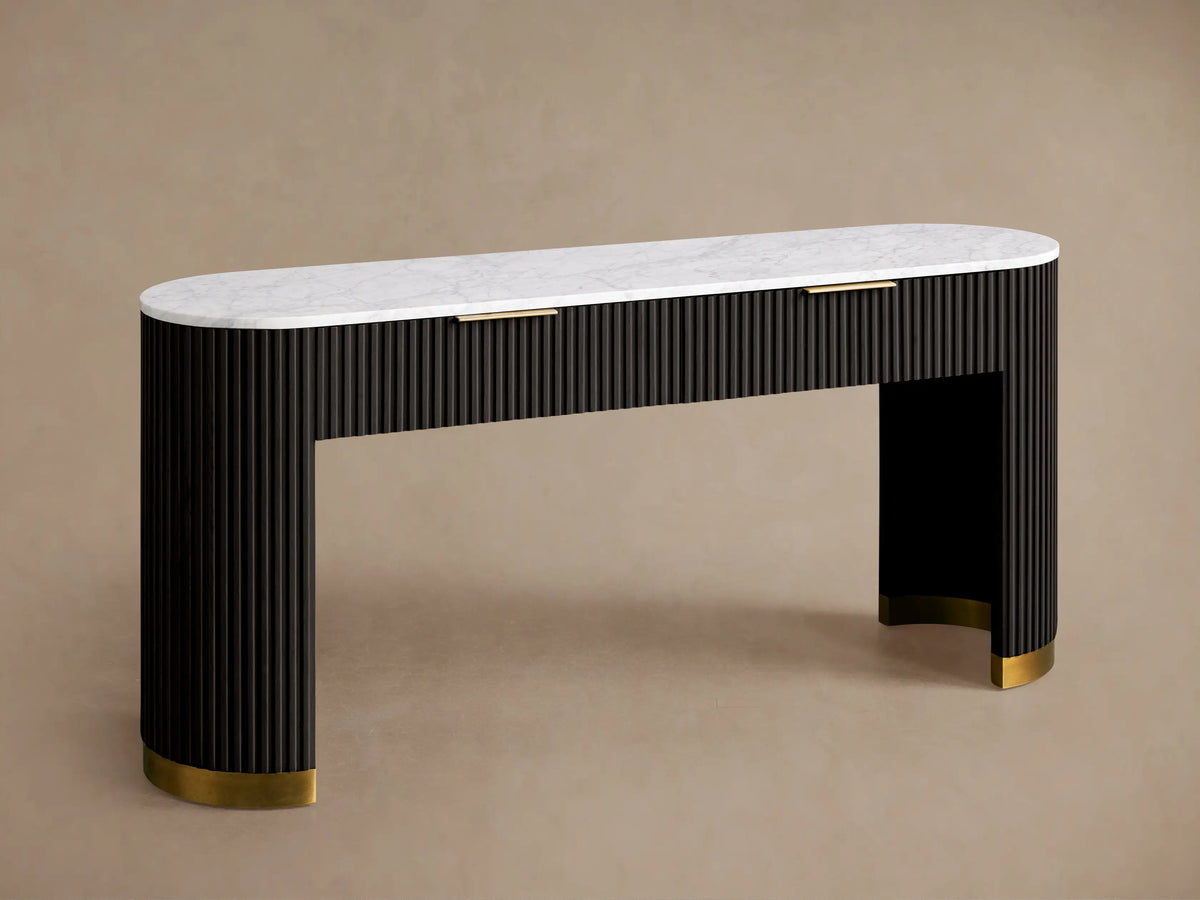 Finnley Storage Console Table in dark wood with brass plinth base, featuring a white top, a book, vase, and sculpture on it.