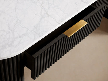 Finnley Storage Console Table with a dark ribbed body, oval white top, and brass accents on curved legs against a beige background.
