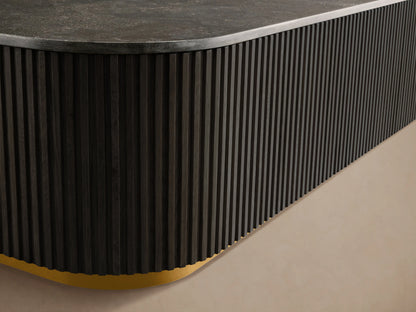 Finnley Coffee Table with a sleek black finish and ribbed texture on the sides, featuring a rectangular shape with rounded edges. Brass-finished base.