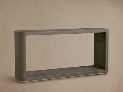 Harrow Console Table with gray faux shagreen texture, rectangular shape, wooden base. Holds books and dark bowls on top, candle and dish below.