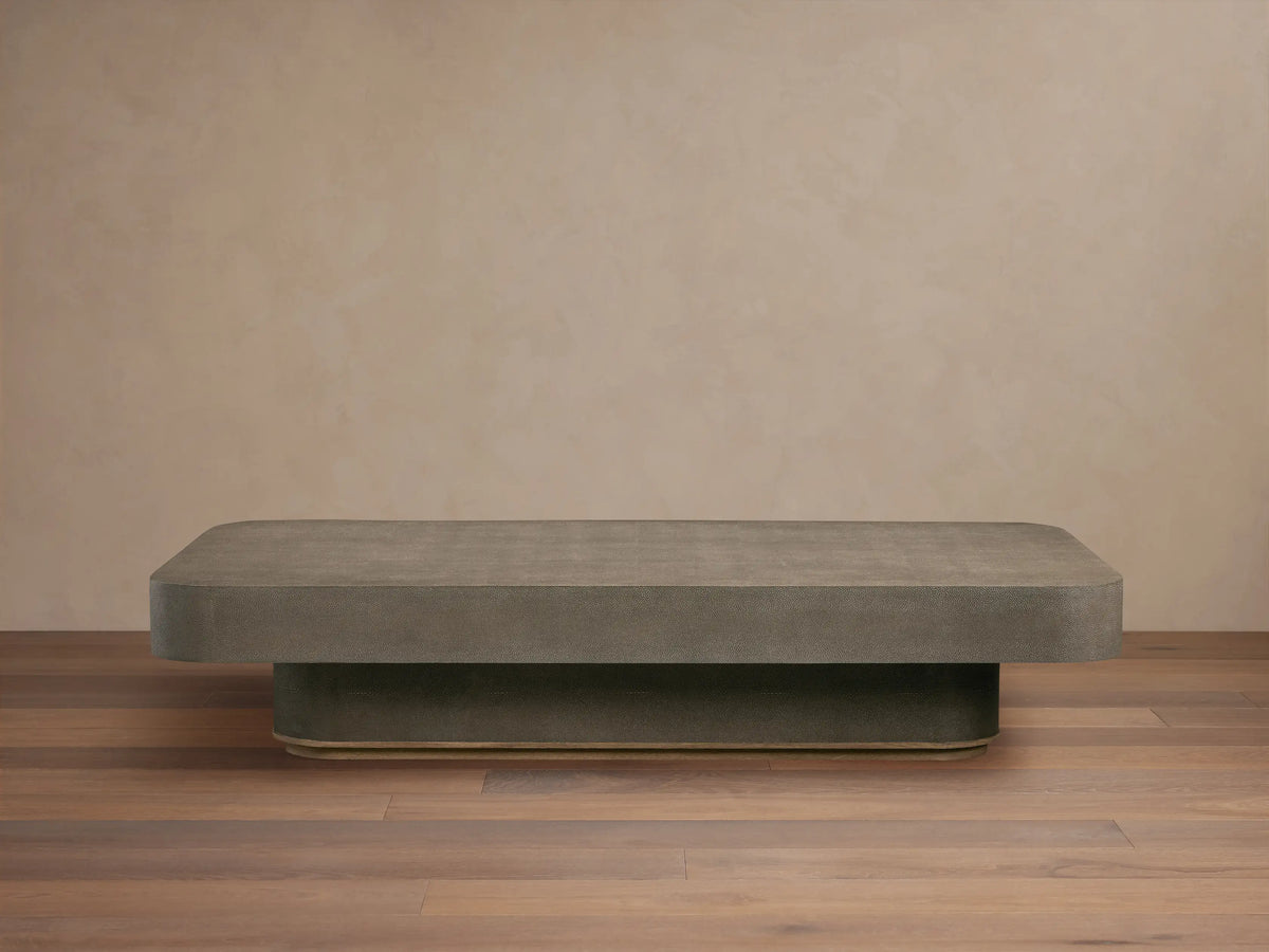Harrow Coffee Table with a rectangular shape, oak hardwood and faux shagreen embossed surface in a neutral color, on wooden floor.