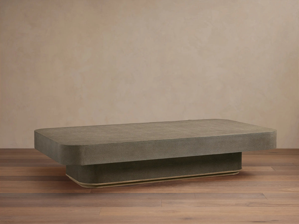 Harrow Coffee Table with a rectangular shape, oak hardwood and faux shagreen embossed surface in a neutral color, on wooden floor.