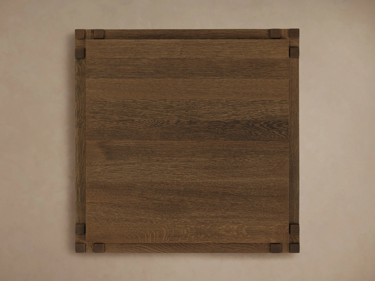 Harlan End Table made of solid oak wood, viewed from above. Square shape with visible wood grain and dark corner accents.