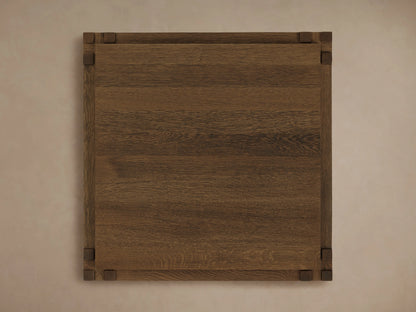 Harlan End Table made of solid oak wood, viewed from above. Square shape with visible wood grain and dark corner accents.