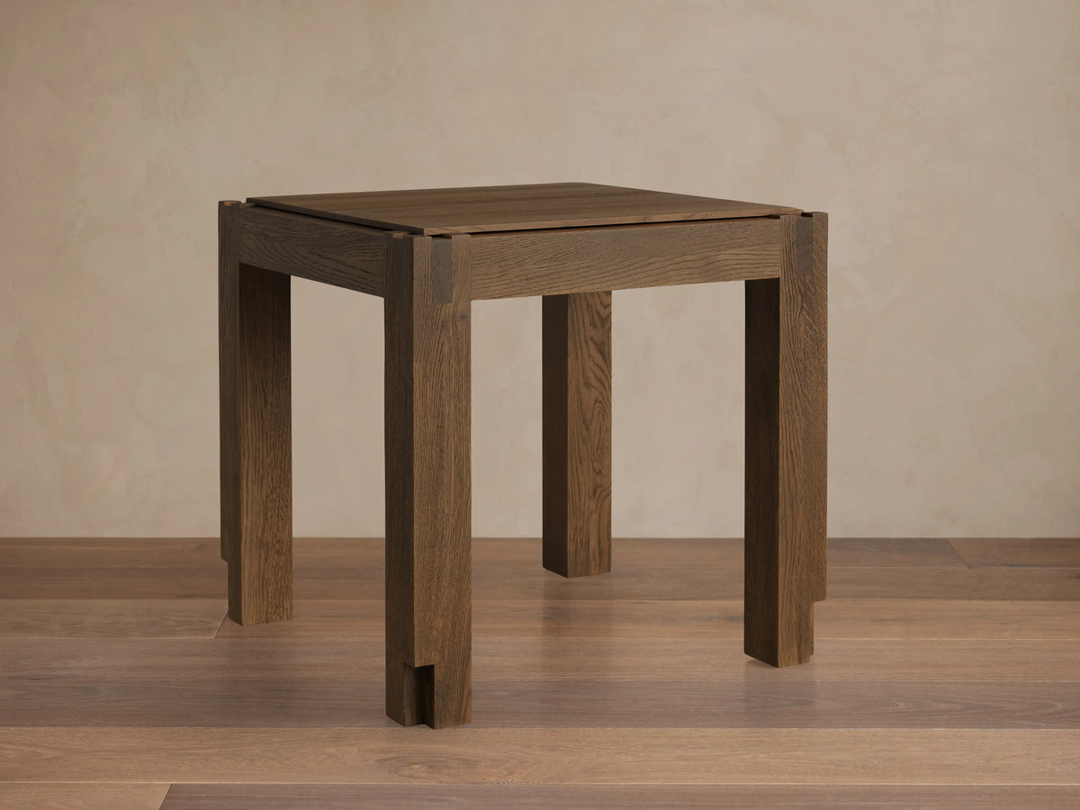 Harlan End Table made of solid oak with a warm brown stain, showcasing the square top and sturdy legs, highlighting wood grain texture.