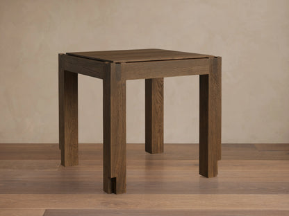 Harlan End Table made of solid oak with a warm brown stain, showcasing the square top and sturdy legs, highlighting wood grain texture.
