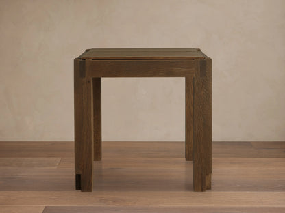 Harlan End Table viewed from above, showcasing its square solid oak wood top with visible grain and corner block details.