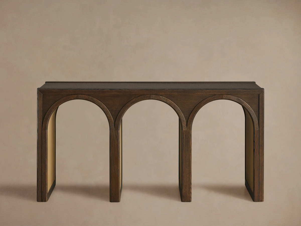 Close-up Hattie Console Table. Dark oak wood grain visible on top & arched supports. Lighter, contrasting arch interiors.