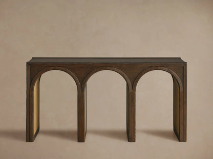 Close-up Hattie Console Table. Dark oak wood grain visible on top & arched supports. Lighter, contrasting arch interiors.