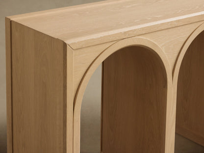 Hattie Console Table made of solid oak wood with three arch-shaped supports, light finish, and contrasting interiors.