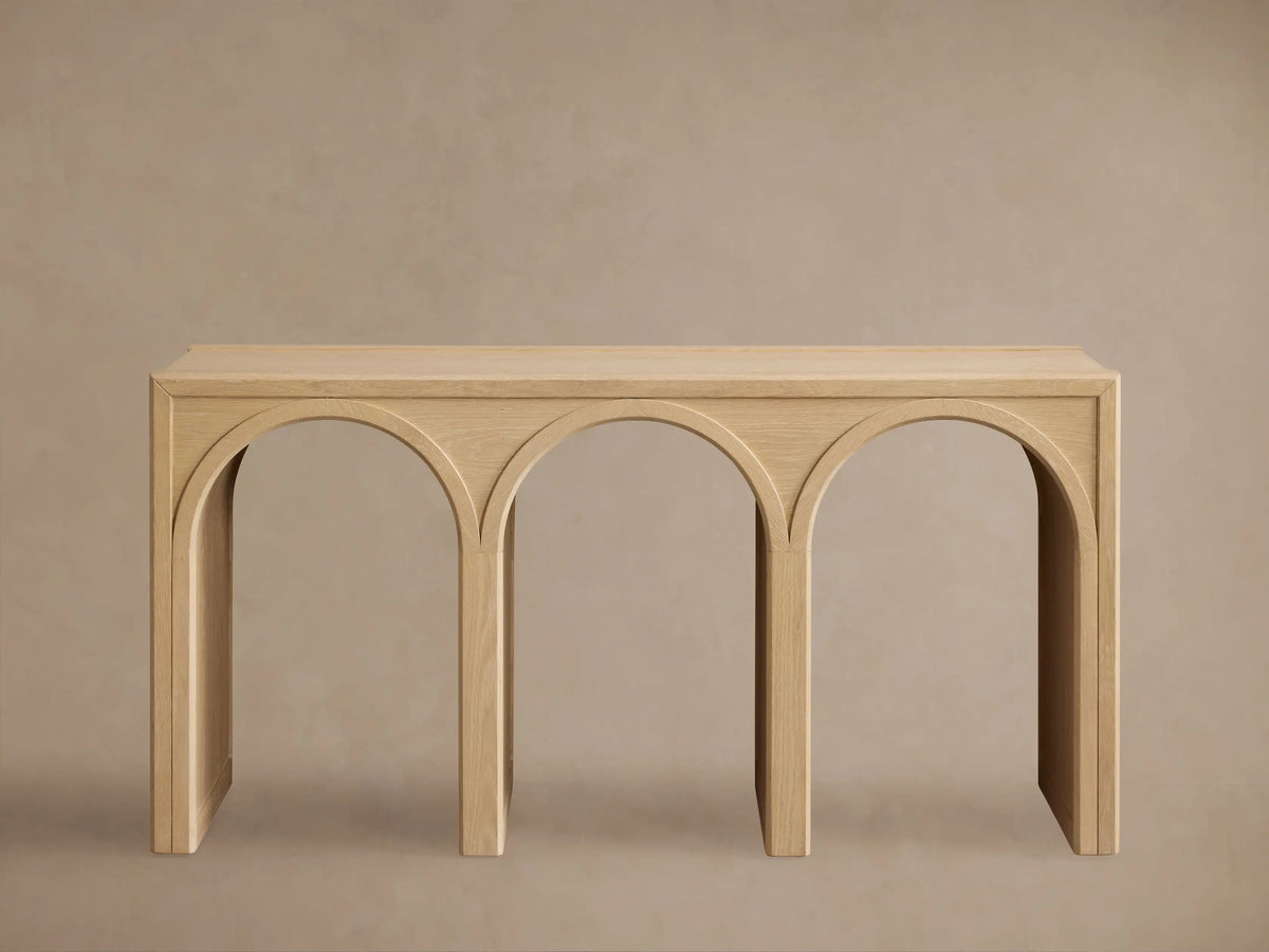 Hattie Console Table made of solid oak with a natural finish, featuring two arch-shaped cutouts with contrasting interiors.