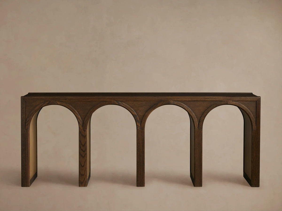 Hattie Console Table made of dark solid oak wood with arch interiors in a contrasting lighter finish, showcasing craftsmanship.