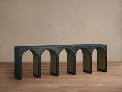 Hattie Console Table with black arches and contrasting interiors, holding a decorative vase and two tall candle holders on top.