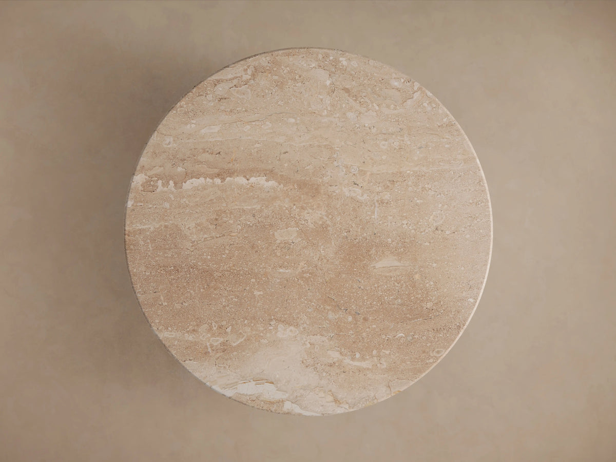 Hemmings Stone Nesting Coffee Table; round, beige stone tabletop with natural veining and subtle sheen, viewed from above.