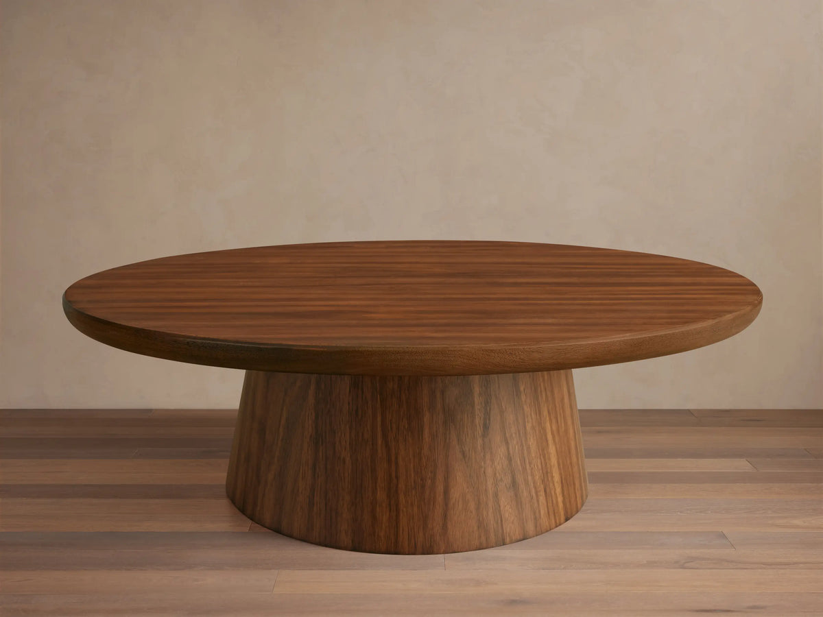Hemmings Nesting Coffee Table. Round, dark walnut veneer tabletop on a sturdy, tapering cylindrical base. Rich wood grain.