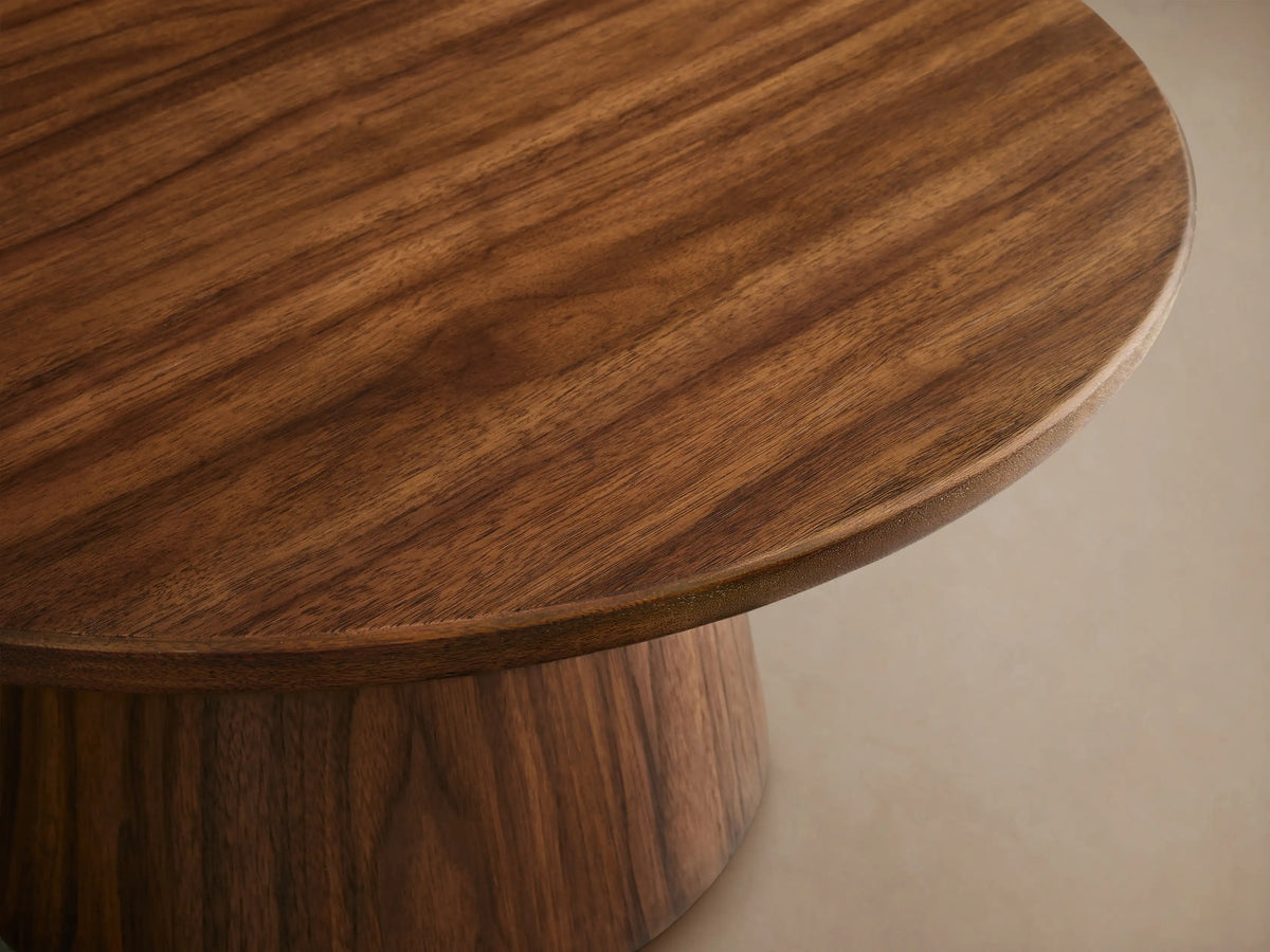Hemmings Nesting Coffee Table. Four round dark brown wood tables with drum bases on a wooden floor, varying heights and sizes.