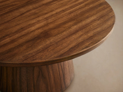 Hemmings Nesting Coffee Table. Four round dark brown wood tables with drum bases on a wooden floor, varying heights and sizes.
