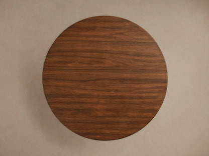 Close-up of Hemmings Nesting Coffee Table, showing round top and cylindrical base with rich brown walnut wood grain.