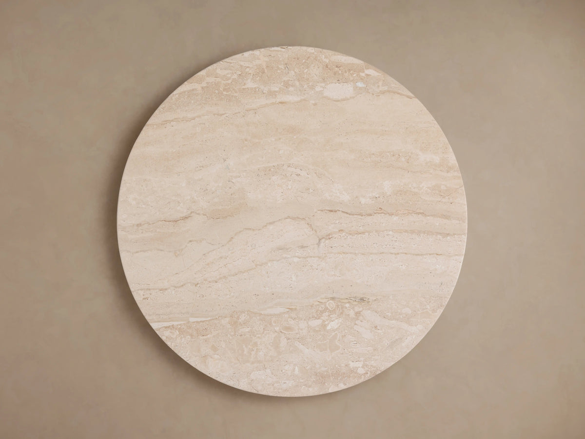 Close-up of Hemmings Stone Nesting Coffee Table, showcasing the beige coralle marble tabletop with natural swirling patterns and a subtle sheen.