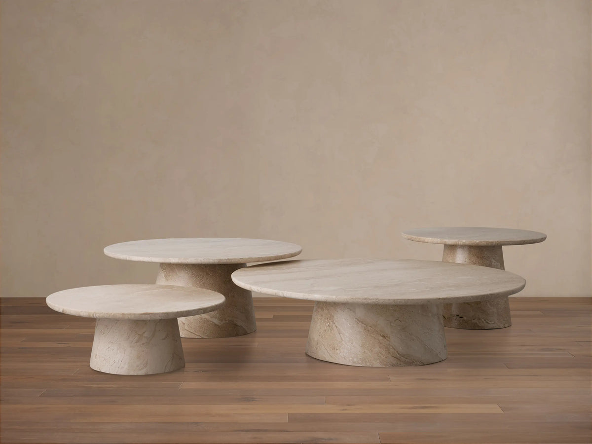 Round beige coralle marble tabletop with natural swirling patterns and veining, viewed from above, set against a neutral background.