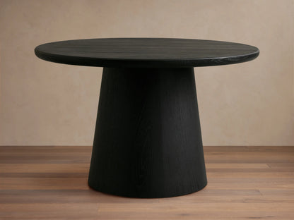 Black round Hemmings Nesting Coffee Table with a smooth dark wood veneer finish. The table has a conical base and rests on a light wood floor.