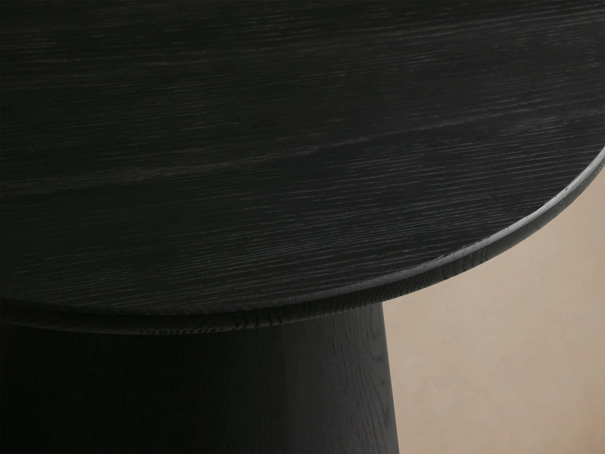 Close-up of the Hemmings Nesting Coffee Table showing a smooth, dark wood veneer surface with subtle grain patterns and rounded edges.