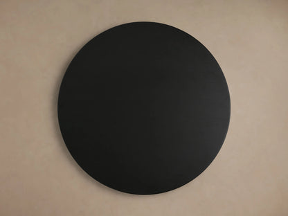 Circular tabletop of the Hemmings Nesting Coffee Table in black oak wood veneer finish, against a beige background.