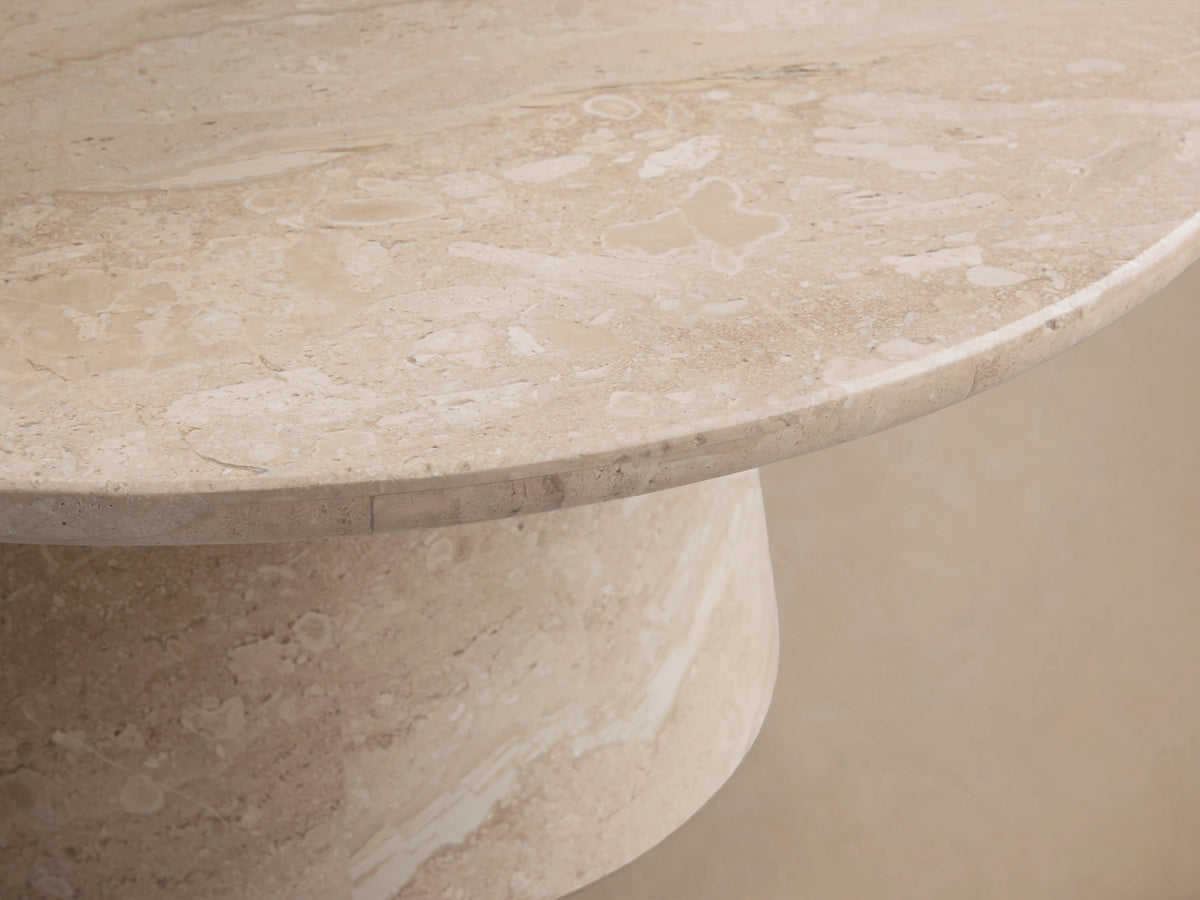 Hemmings Stone Nesting Coffee Table with a beige coralle marble top and conical base, showcasing natural patterns and sheen.