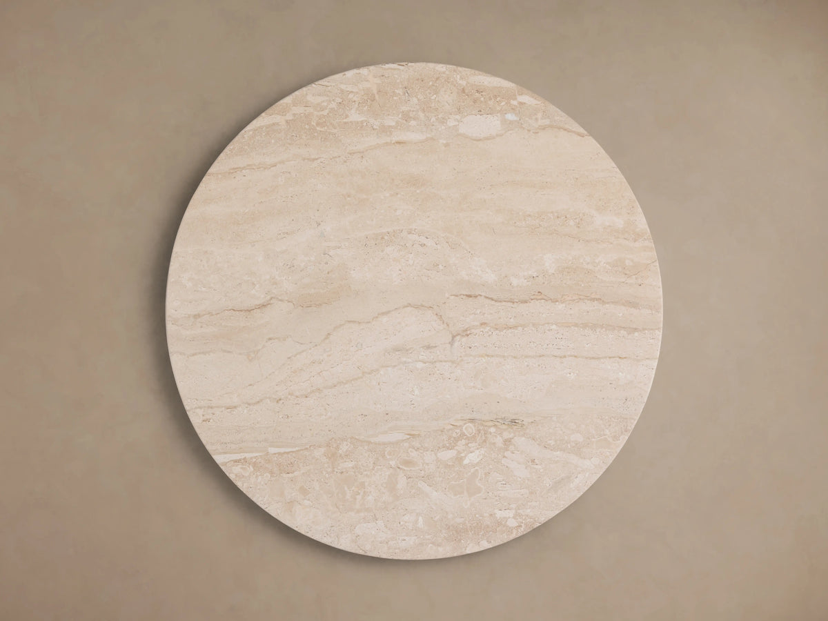 Hemmings Stone Nesting Coffee Table features a smooth beige coralle marble top with natural variations, showcasing its circular shape.