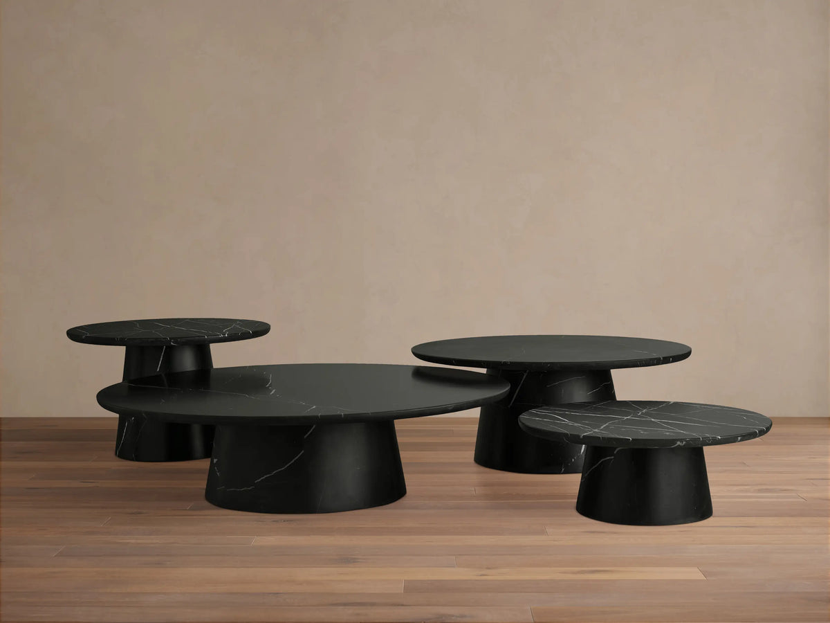 Close-up of the Hemmings Stone Nesting Coffee Table in black marquina marble, showing a rounded edge and natural white veining patterns.