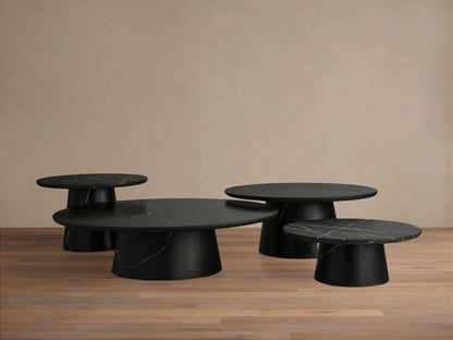 Close-up of the Hemmings Stone Nesting Coffee Table in black marquina marble, showing a rounded edge and natural white veining patterns.