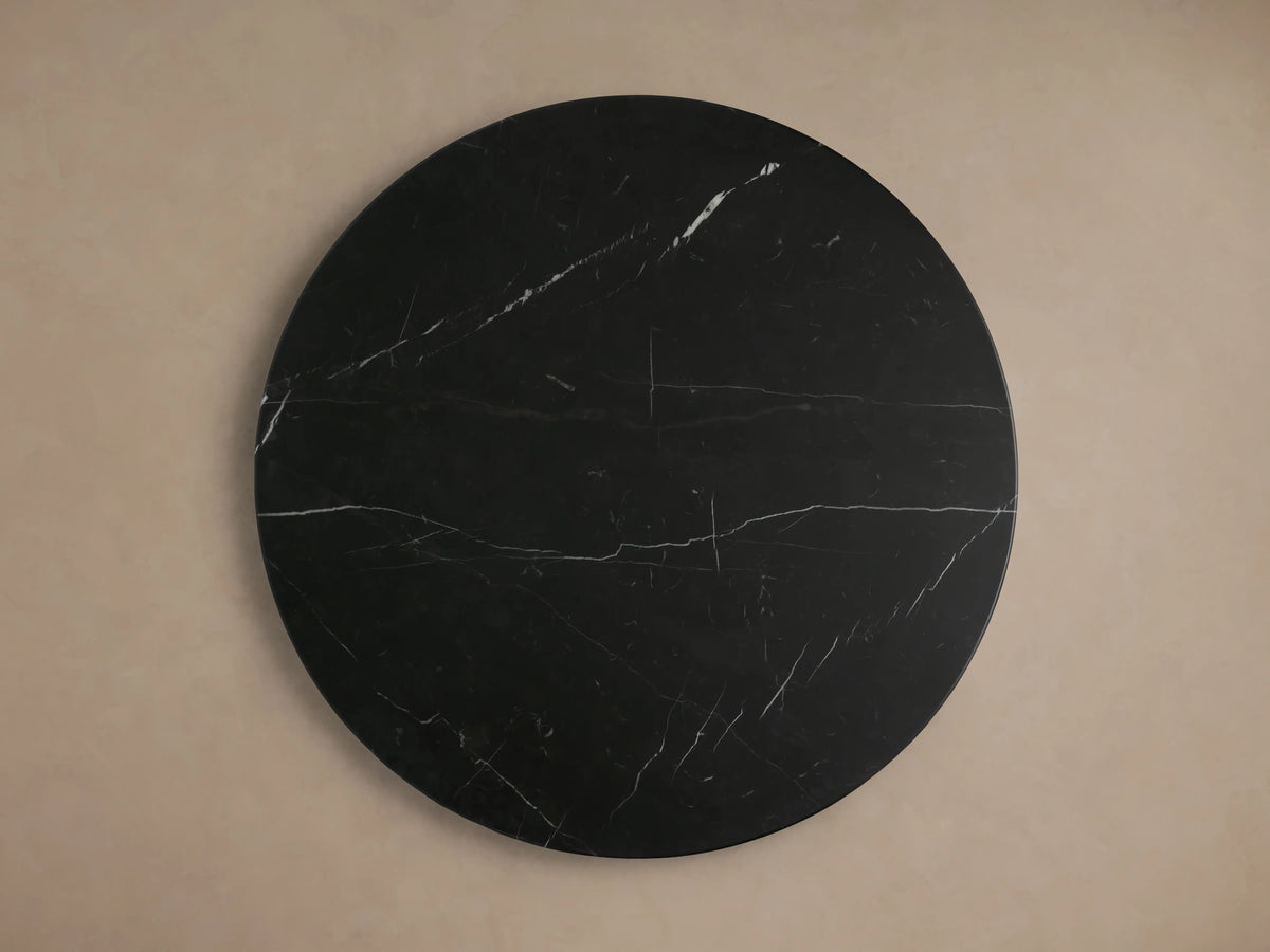 Hemmings Stone Nesting Coffee Table set: four round black marble tables with white veining, varying heights, on wood floor.