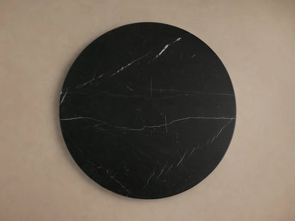 Hemmings Stone Nesting Coffee Table set: four round black marble tables with white veining, varying heights, on wood floor.