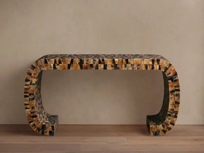 Interior view of Lindly Console Table with a rounded silhouette, detailed with mosaic-like natural buffalo horn in brown and black. Flowers on top.