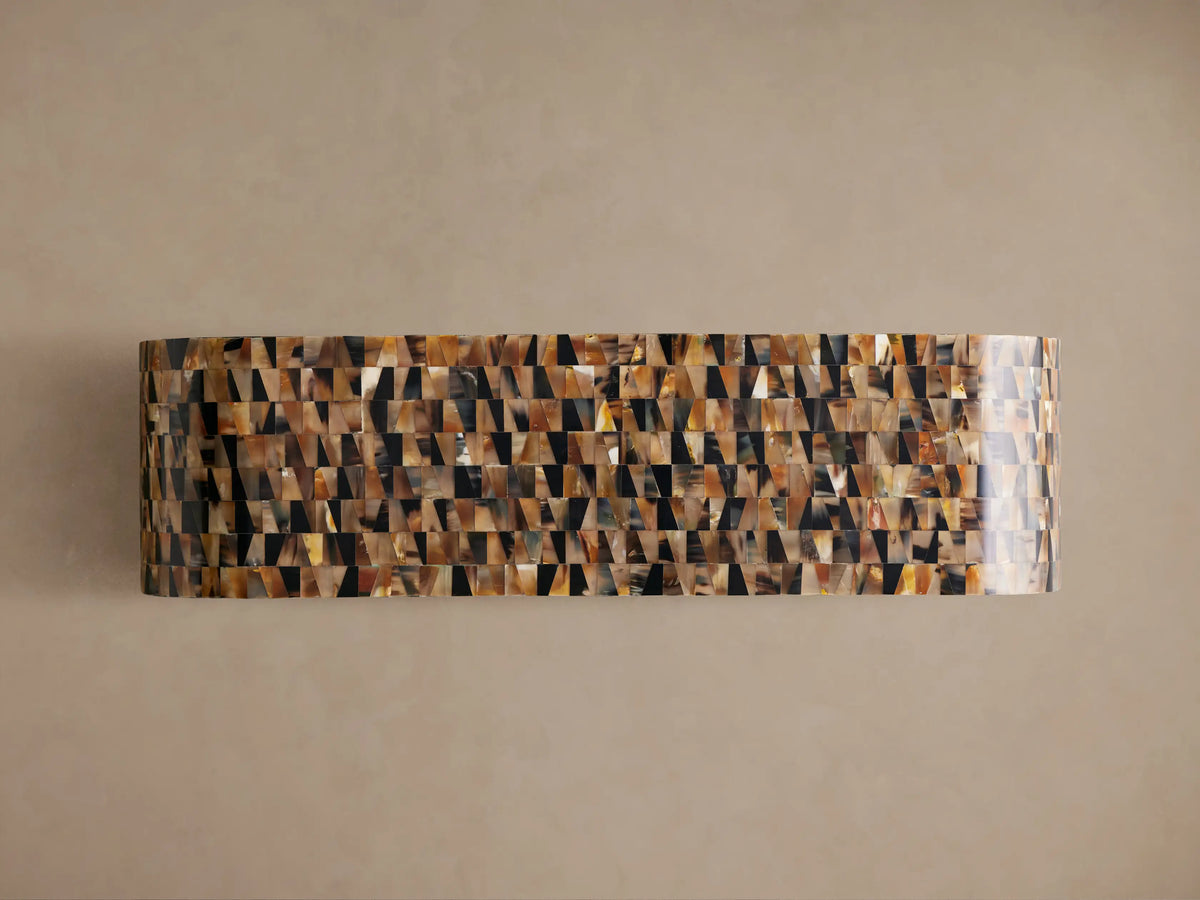 Lindly Console Table, a rounded, C-shaped table with a mosaic pattern of natural amber, brown, and black buffalo horn pieces.