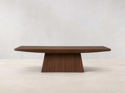 Ilaria Coffee Table with a rectangular walnut finish, featuring a wide, flat surface and tapered, sturdy base on wooden floor.